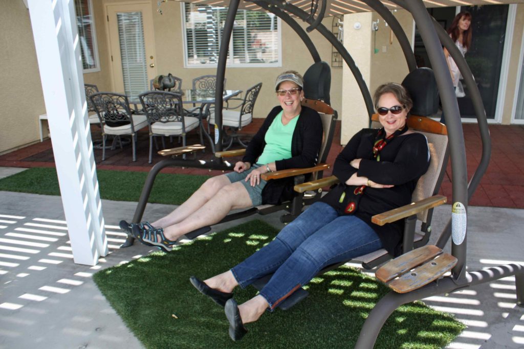 Judy Hayes and Michelle Edwards enjoy the mild north county weather while watching garden trains operate in comfort.