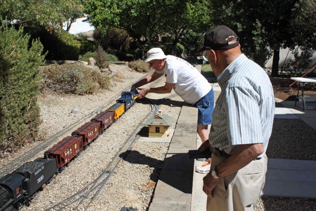 Our host, Jim Davis, connects his digital camera car to the rear of the visiting LGB Mikado consist to capture another perspective of trains operating on the Crown & Summit Railroad.