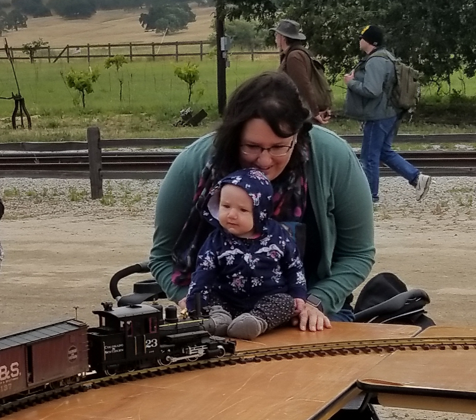 Mother and child watch model train.